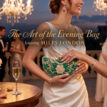 Woman in an evening setting holding an ornate green Miles London clutch